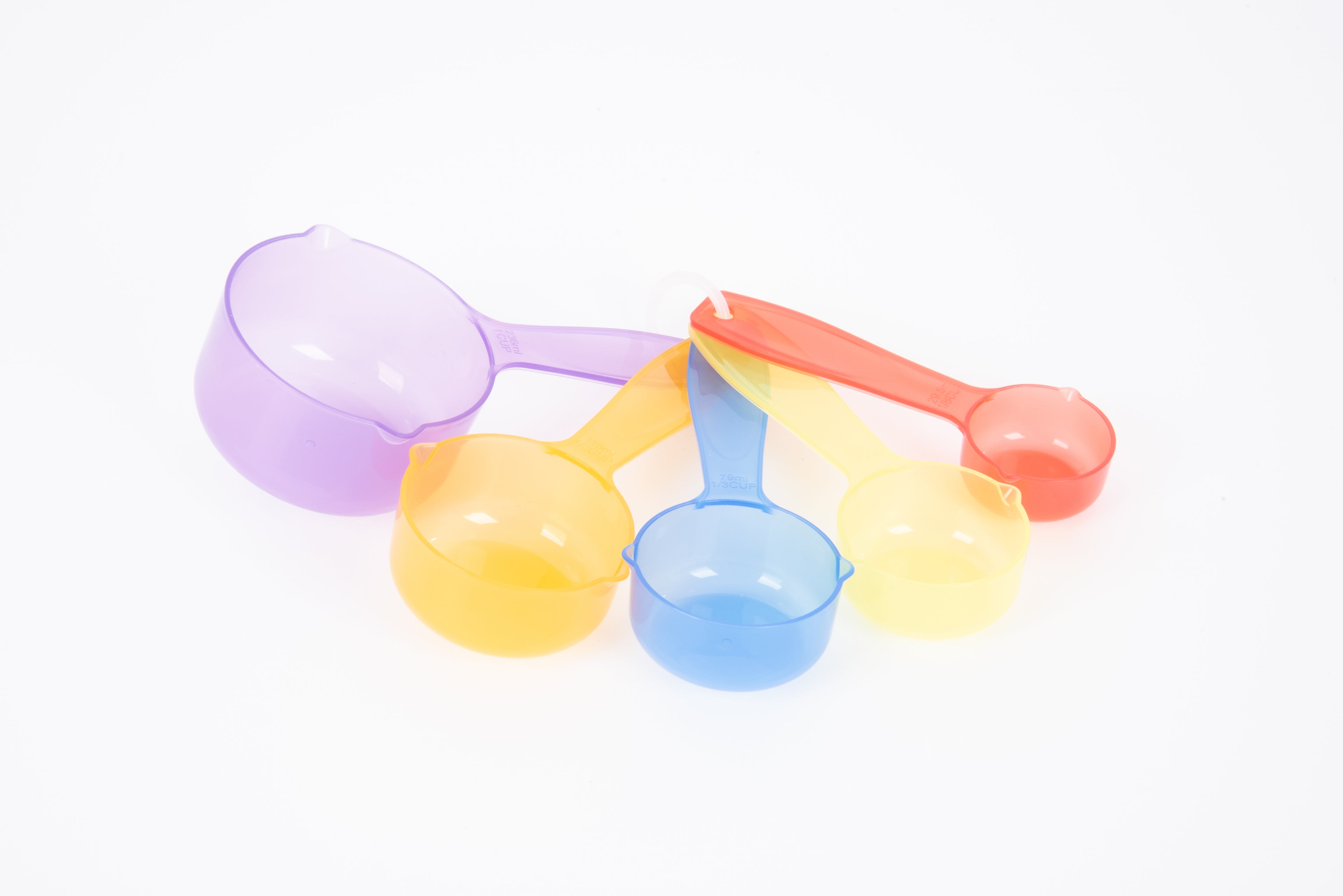 Translucent color measuring cup set with round cups and colored handles, purple, yellow, blue