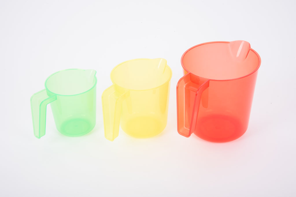 Translucent nesting jugs, mint green and pale yellow cups with coral jug and handle