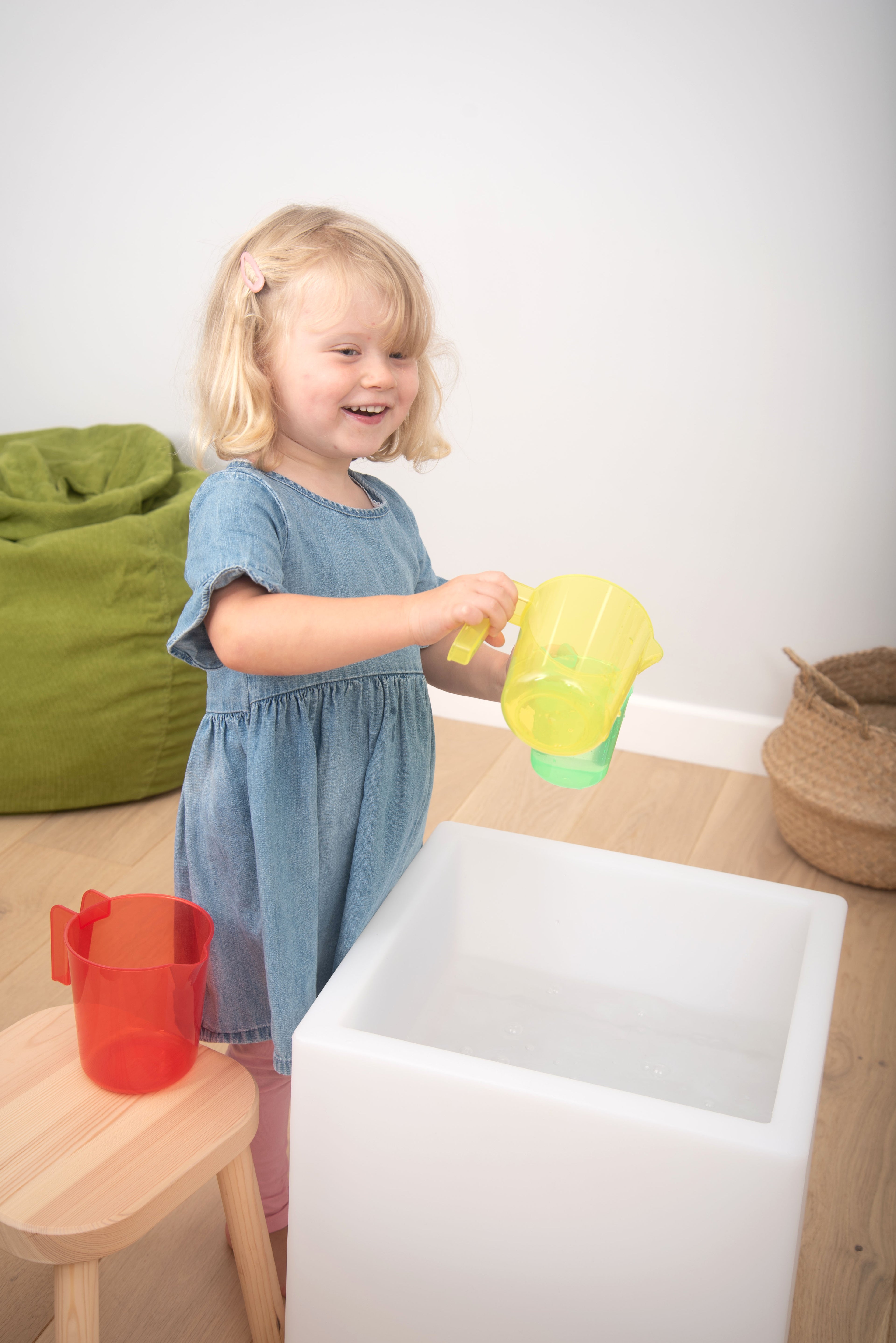 Translucent nesting jug, yellow with green tint, translucent body and pouring spout
