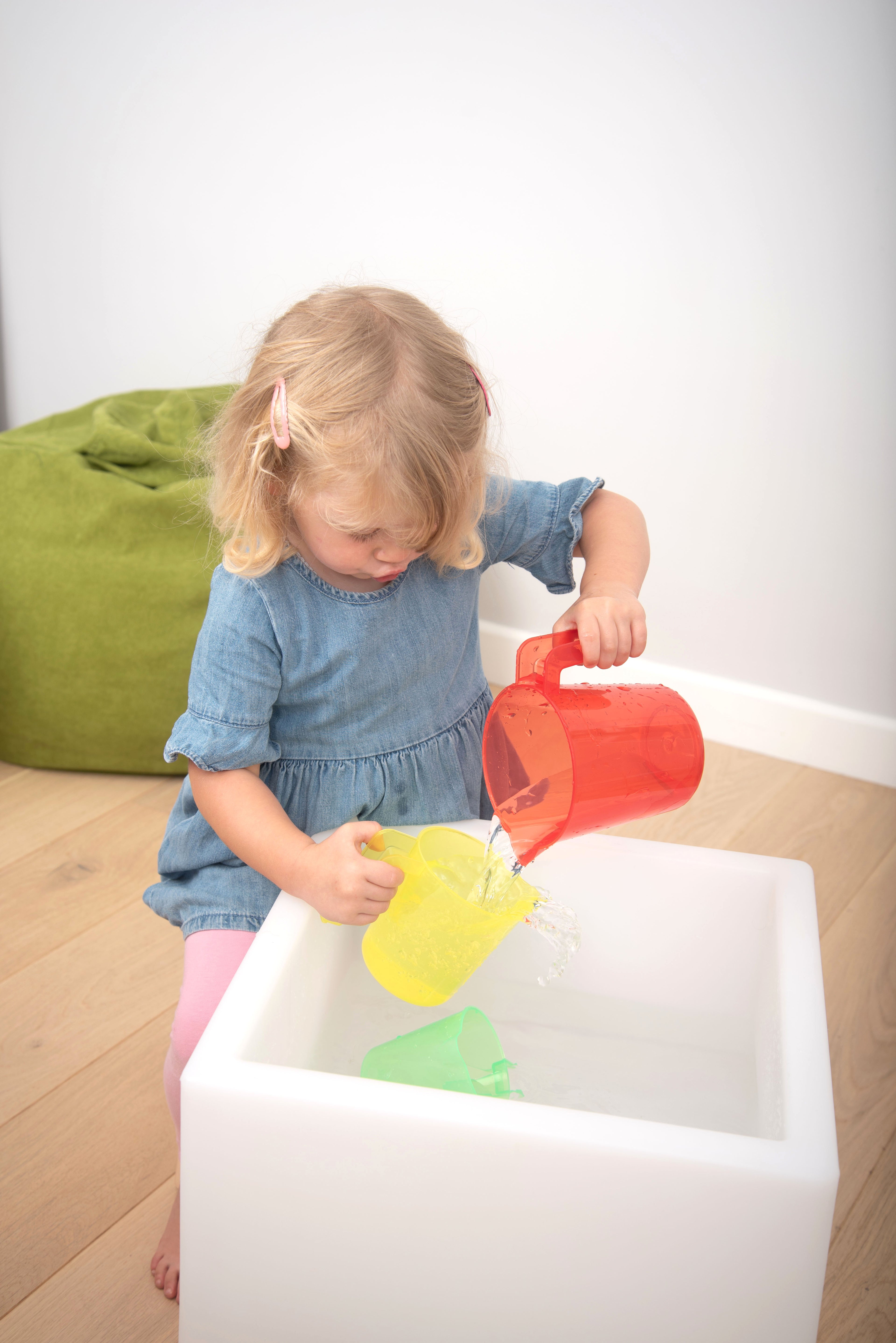 Translucent nesting jugs, red and yellow translucent bodies with handles and spouts