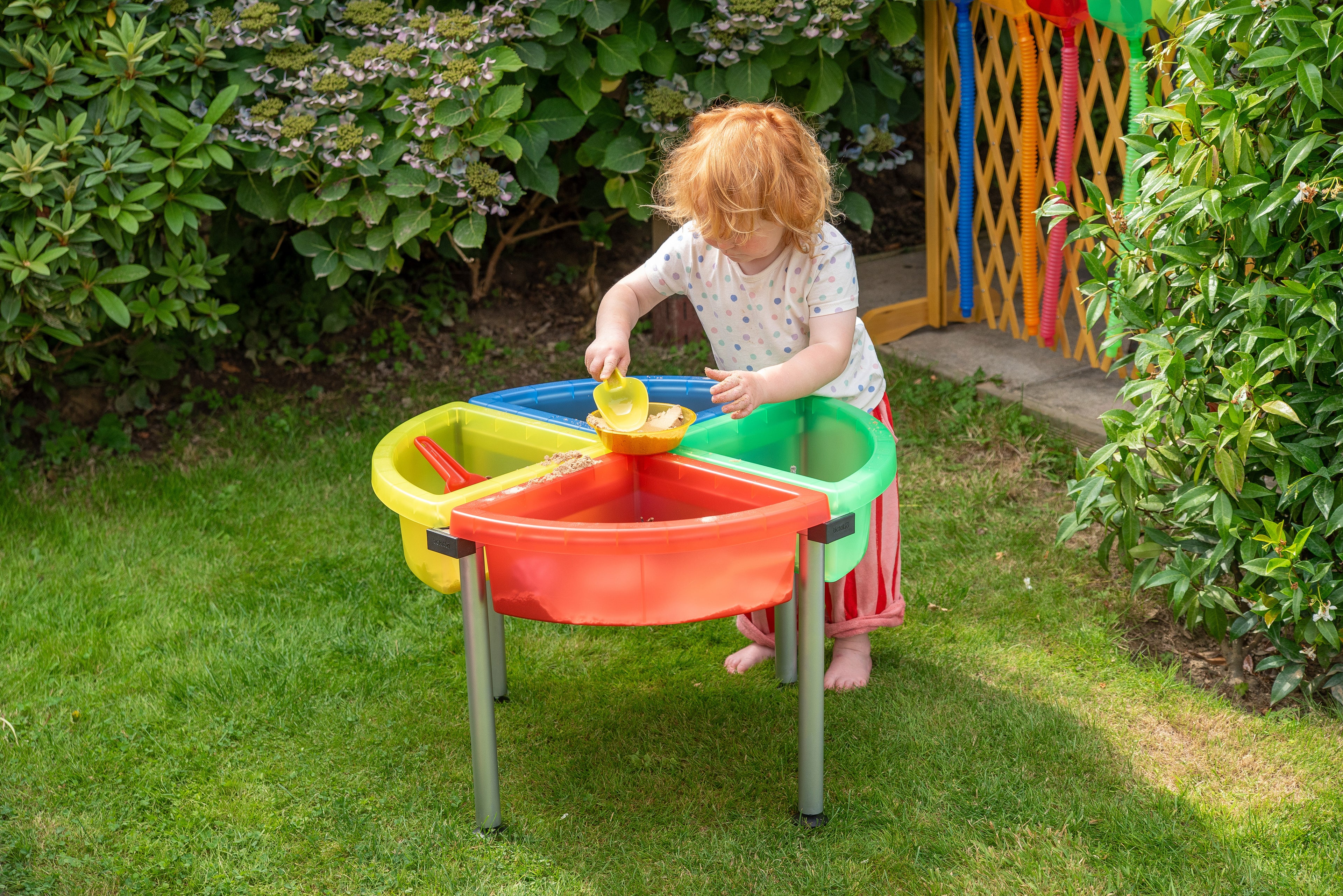 Translucent nesting scoops with yellow and orange scoops in outdoor bin