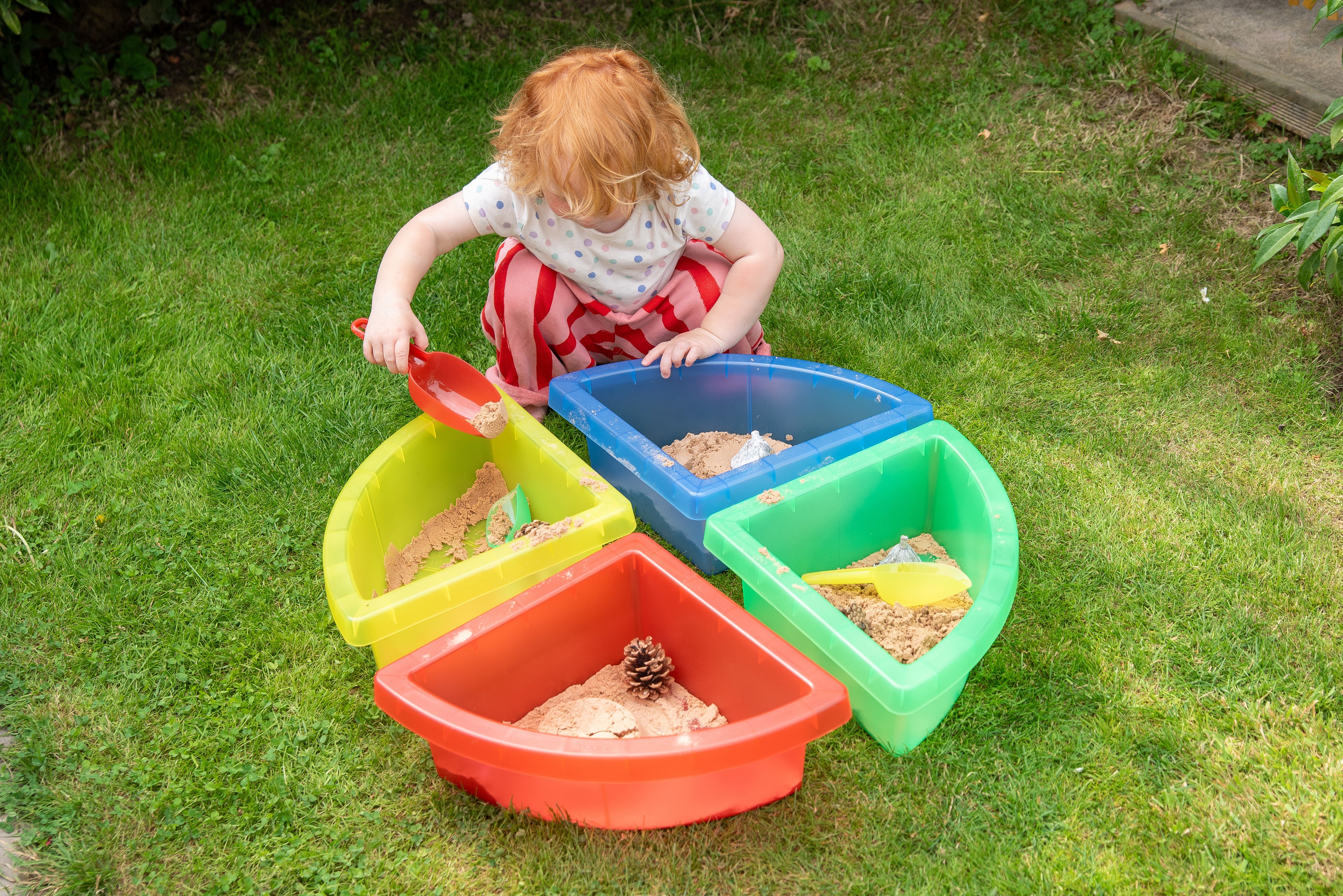 Translucent nesting scoops in multiple colors: red, yellow, and green