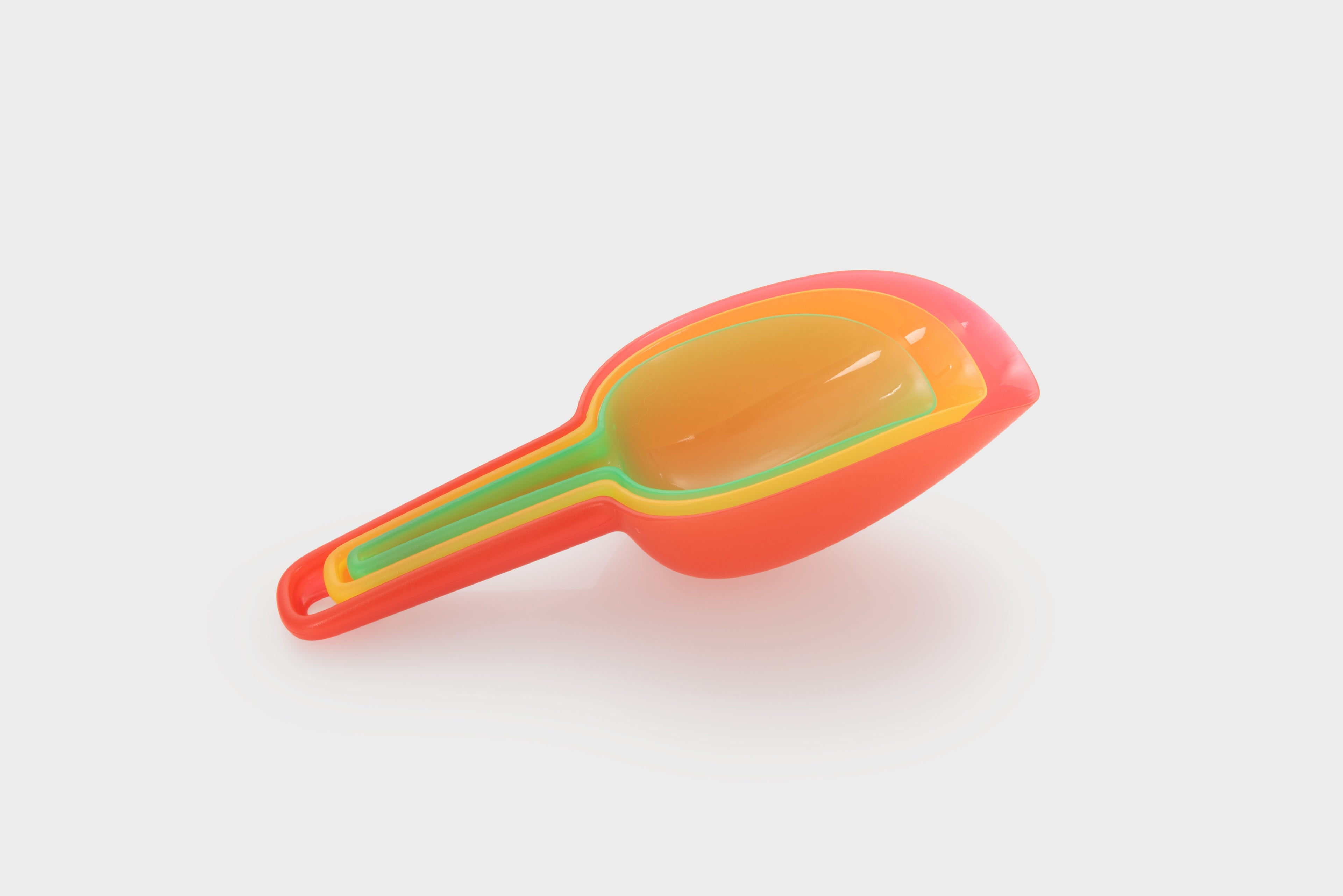 Translucent nesting scoop with orange handle and yellow scoop