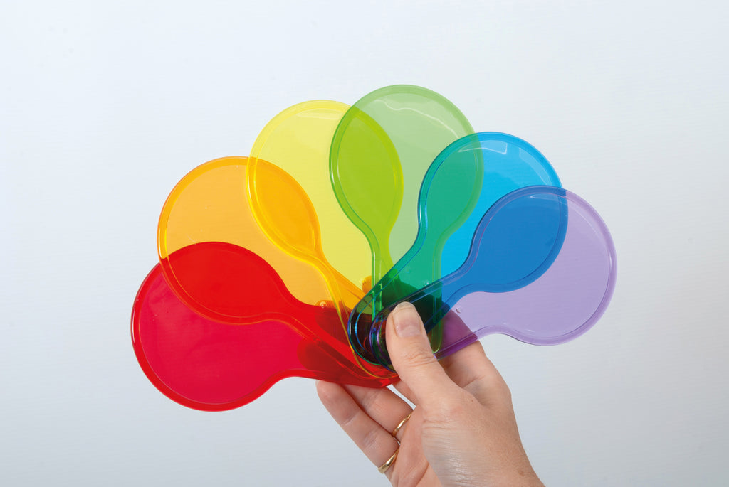 Translucent color paddle toys with handles, held together in mixed colors by one hand.