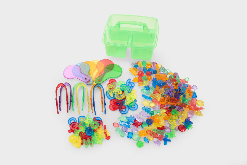 Translucent green tool caddy with scattered colorful number and letter pieces