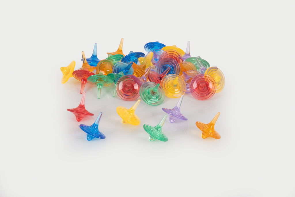 Translucent color spinners set of multicolor swirl tops, arranged in a group and scattered