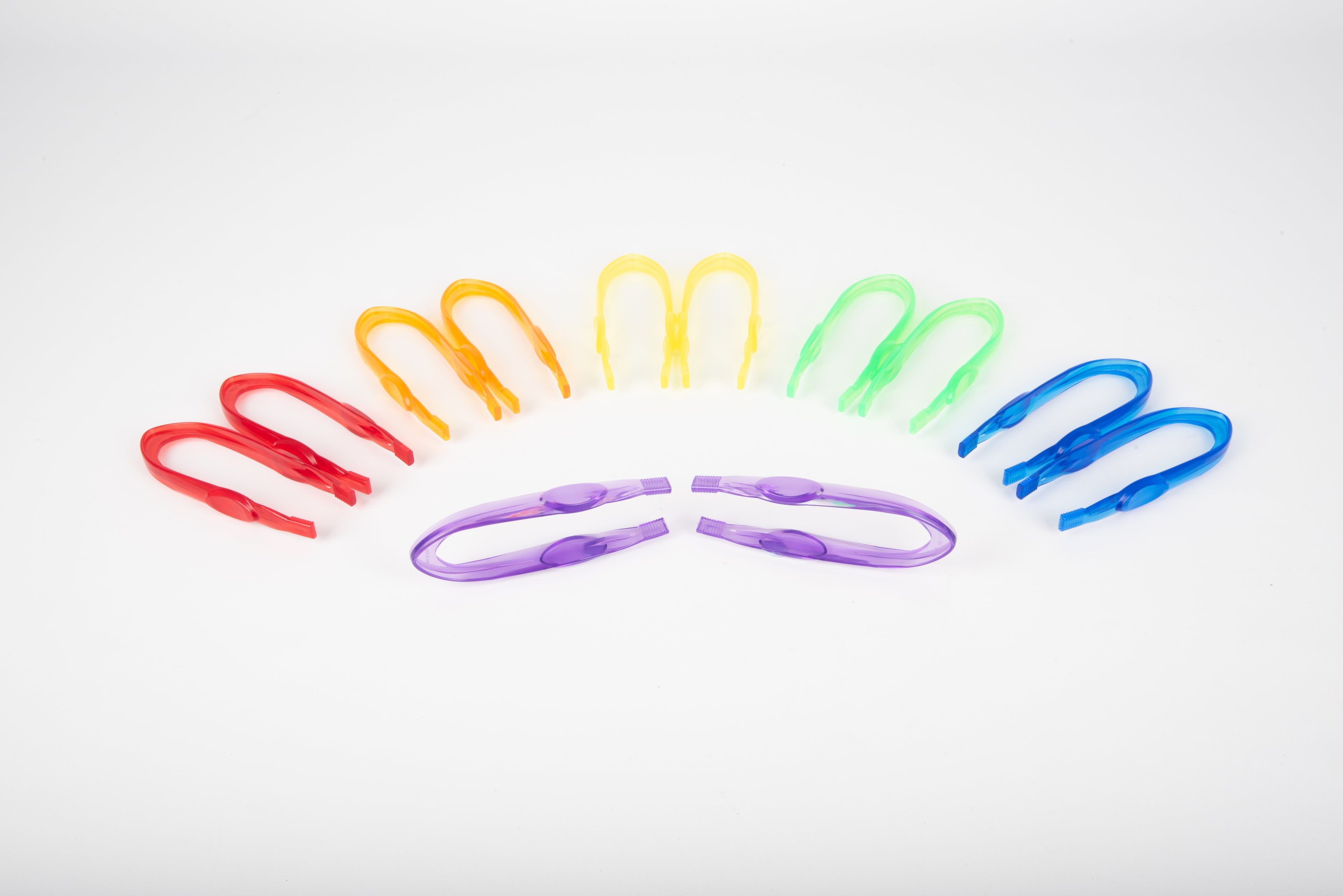Translucent color tweezers set, multicolor grips fanned on a white surface.