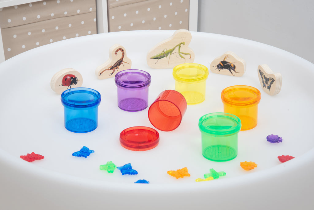 Translucent color viewer cups and animal-shaped slides in a white tray