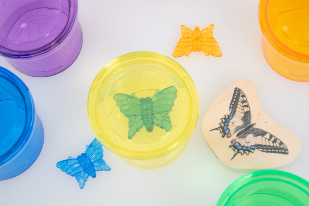 Yellow translucent color viewer cup with butterfly slides and other cup colors