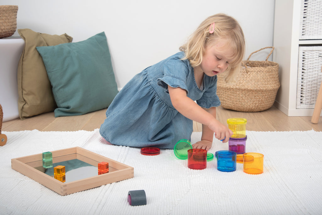 Translucent color viewer cups with colored pieces on a tabletop