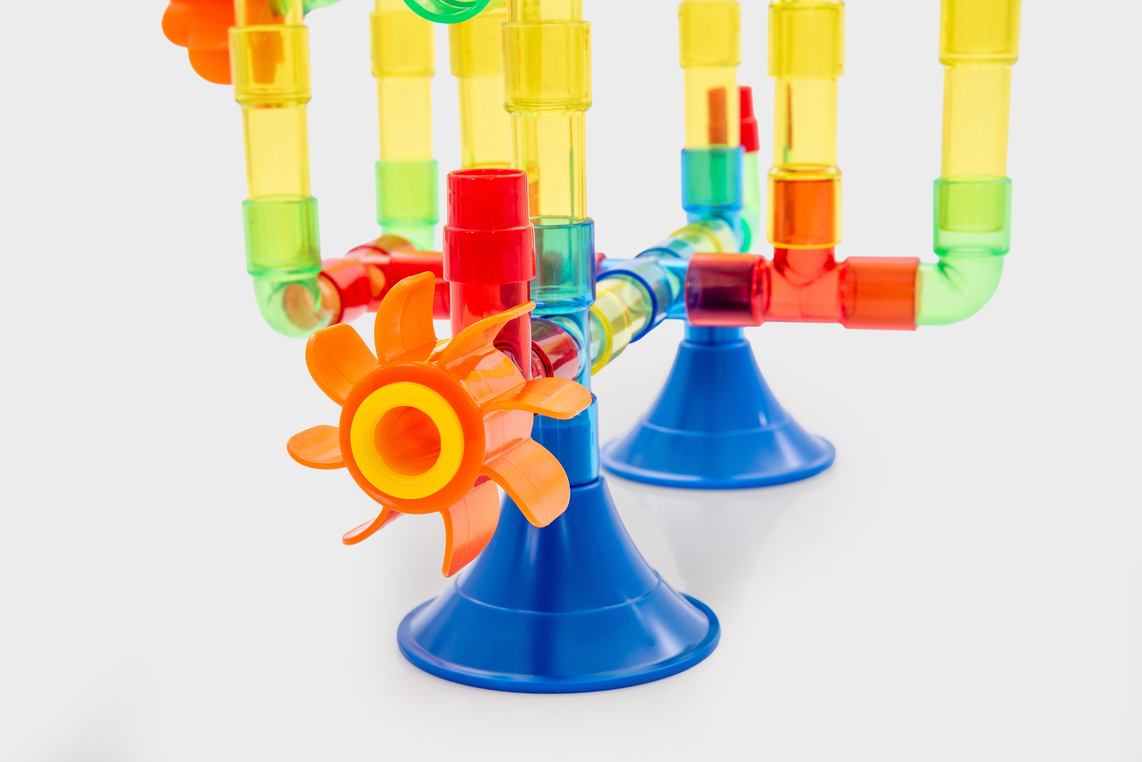 Translucent water pipe toy with three blue stands and colorful connected tubes