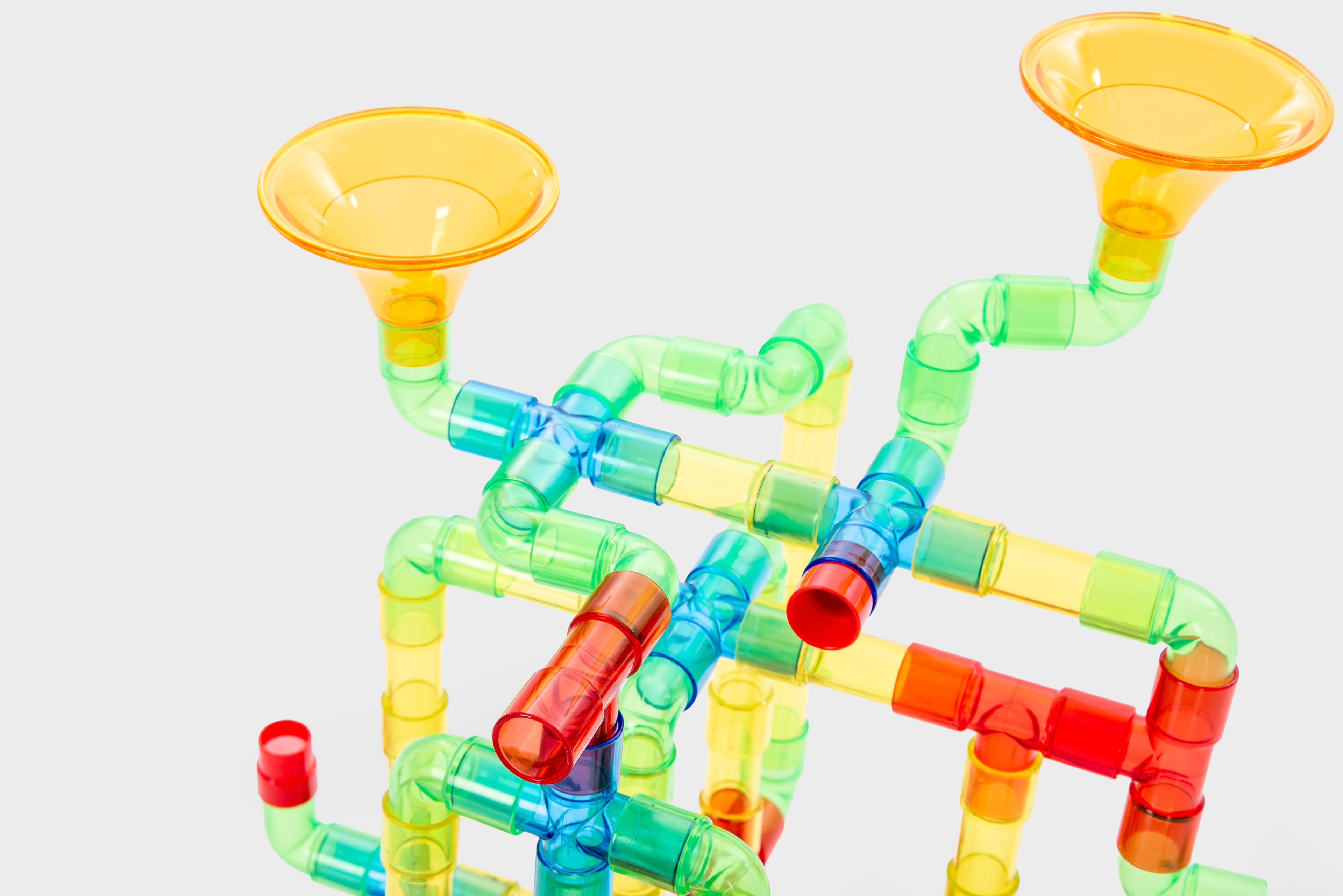 Translucent water pipe toy with multiple colorful tubes and two orange-yellow funnels