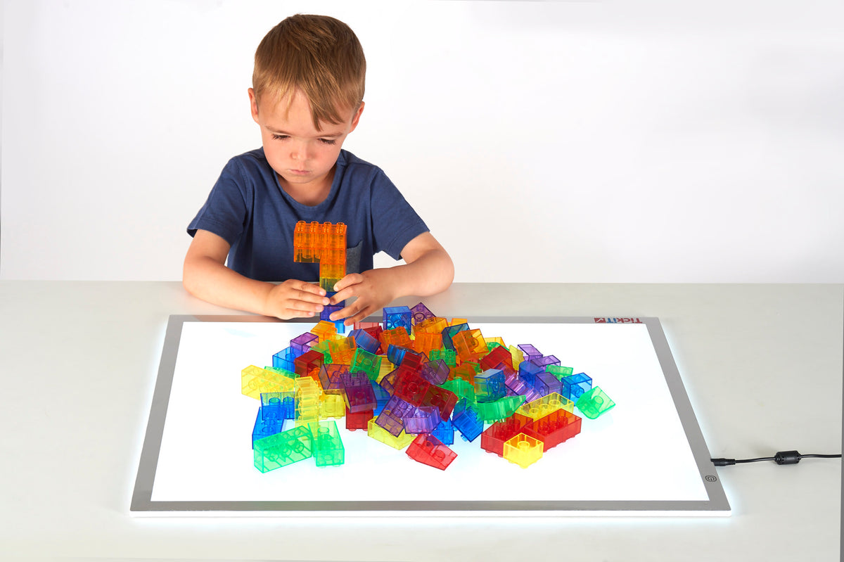 Colorful translucent module blocks on a play tray, assorted shapes