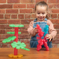 Translucent plastic building set with green base and red/blue interlocking pieces