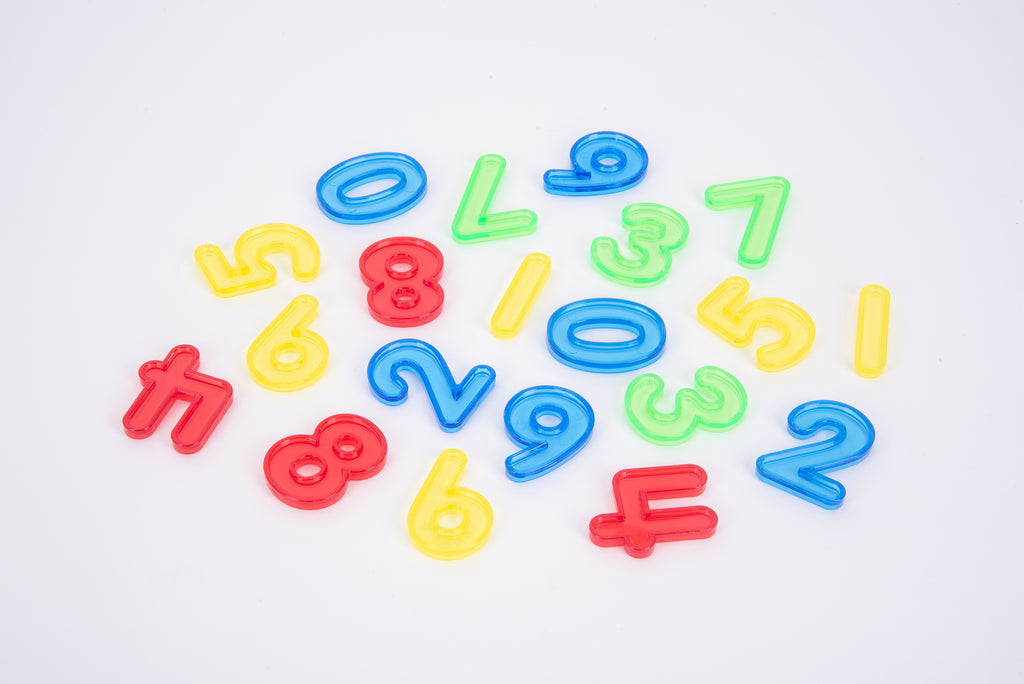 Assorted colorful translucent number pieces scattered on a light background.
