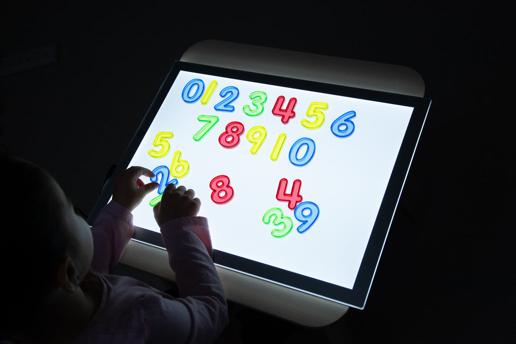 Backlit tablet showing colorful translucent number tiles arranged in rows (0–39).