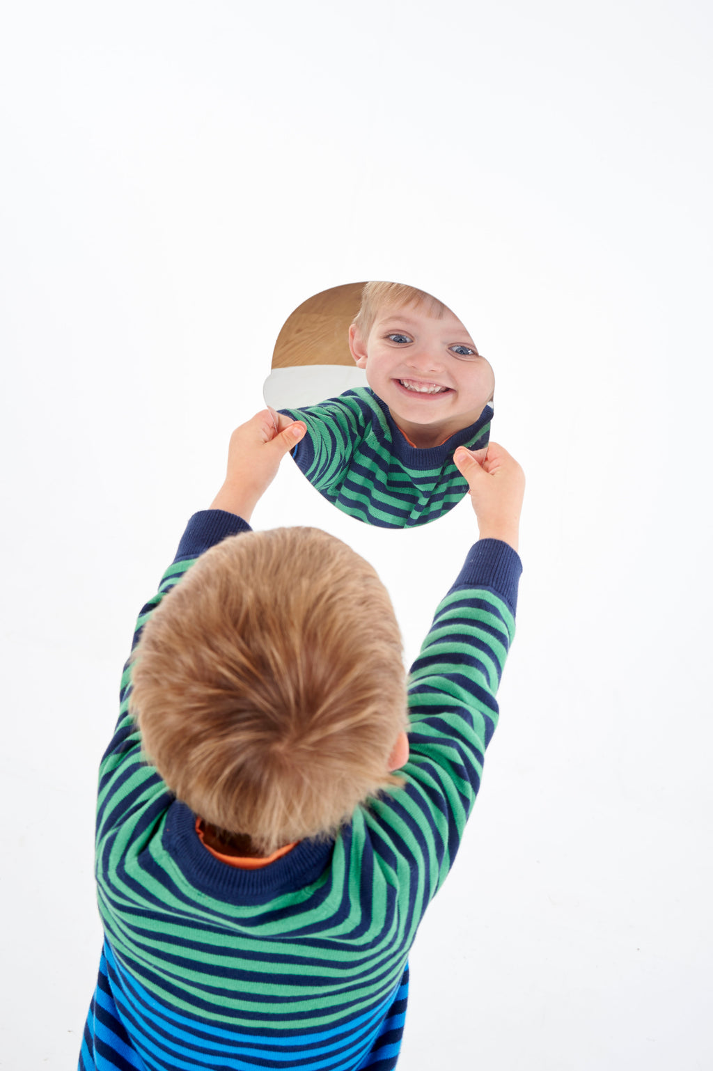 Child holding a black-and-white emotion face card with a happy smile