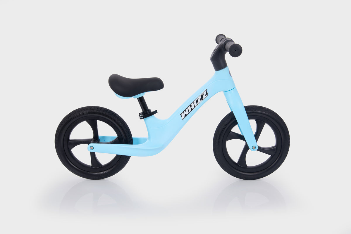 Light blue balance bike with black handlebar grips and black wheels
