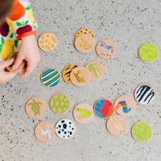Wooden puzzle board with scattered circular colorful pieces