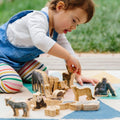 Wooden wild animal figurine set with cutout pieces on play mat