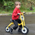 Yellow balance bike with black tires and front number plate 16