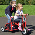 Red kids ride-on fire engine tricycle with black seat and number 8 panel.