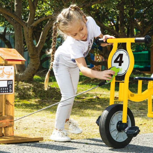 Yellow narrow-axle tricycle with black pedals and seat, number 4 plate, outdoors