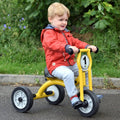 Kids’ small tricycle with yellow frame, black tires, and round front bell