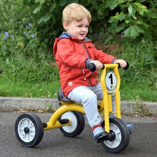 Kids’ small tricycle with yellow frame, black tires, and round front bell