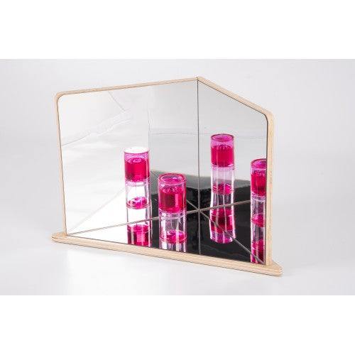 Wood-framed 4-way mirror reflecting stacked pink translucent cylinders