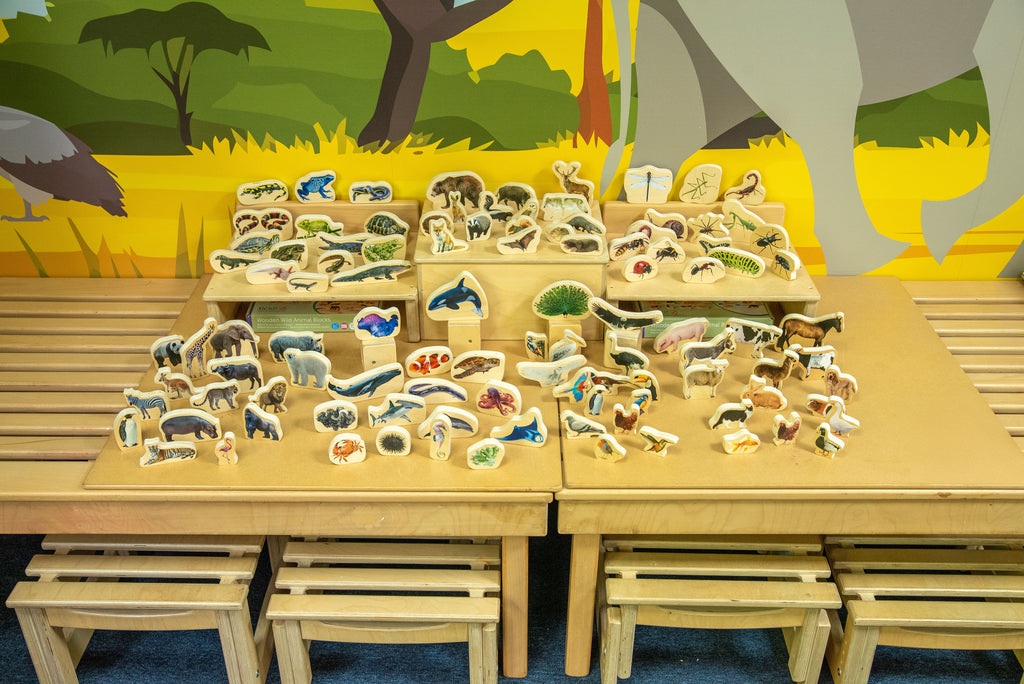 Wooden animal block set with assorted animal pieces arranged on a wooden tabletop