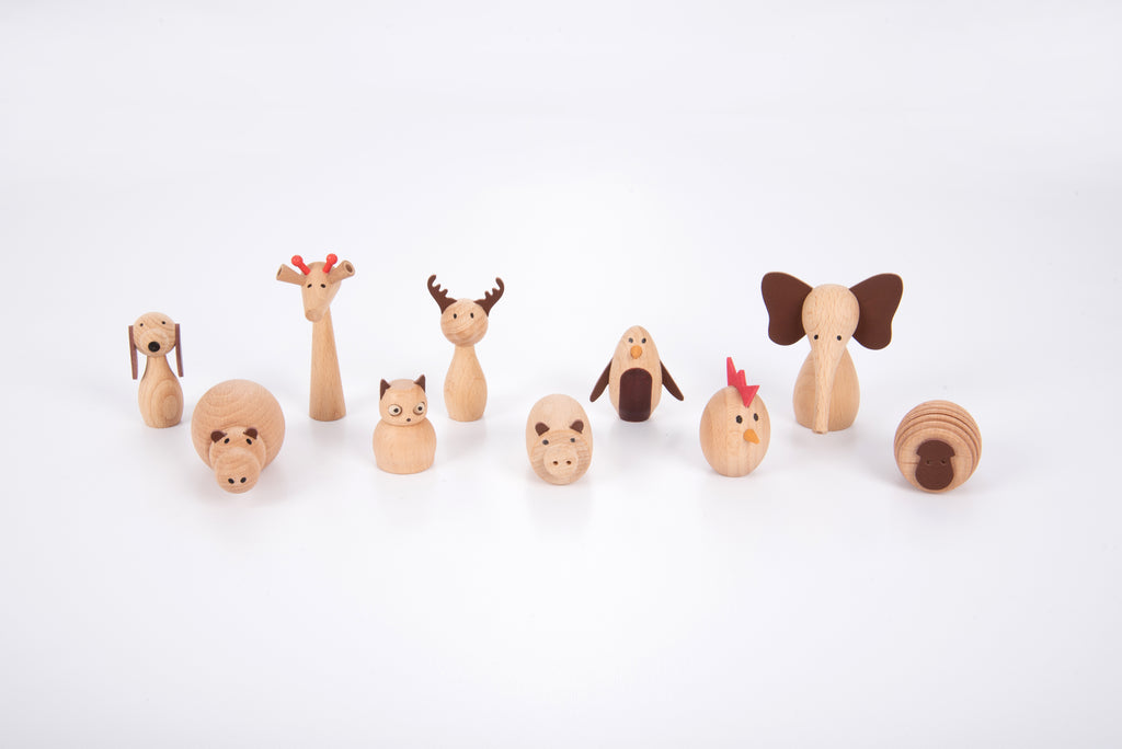 Assorted wooden animal figurines arranged in a row