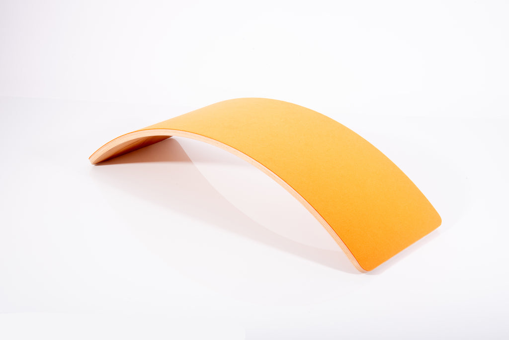 Curved light-wood balance board with orange underside and arched center