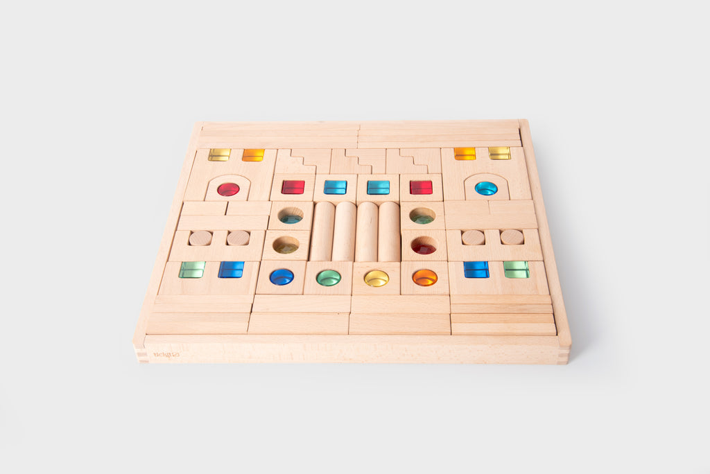 Wooden gem building blocks board with multicolor round and square pieces.