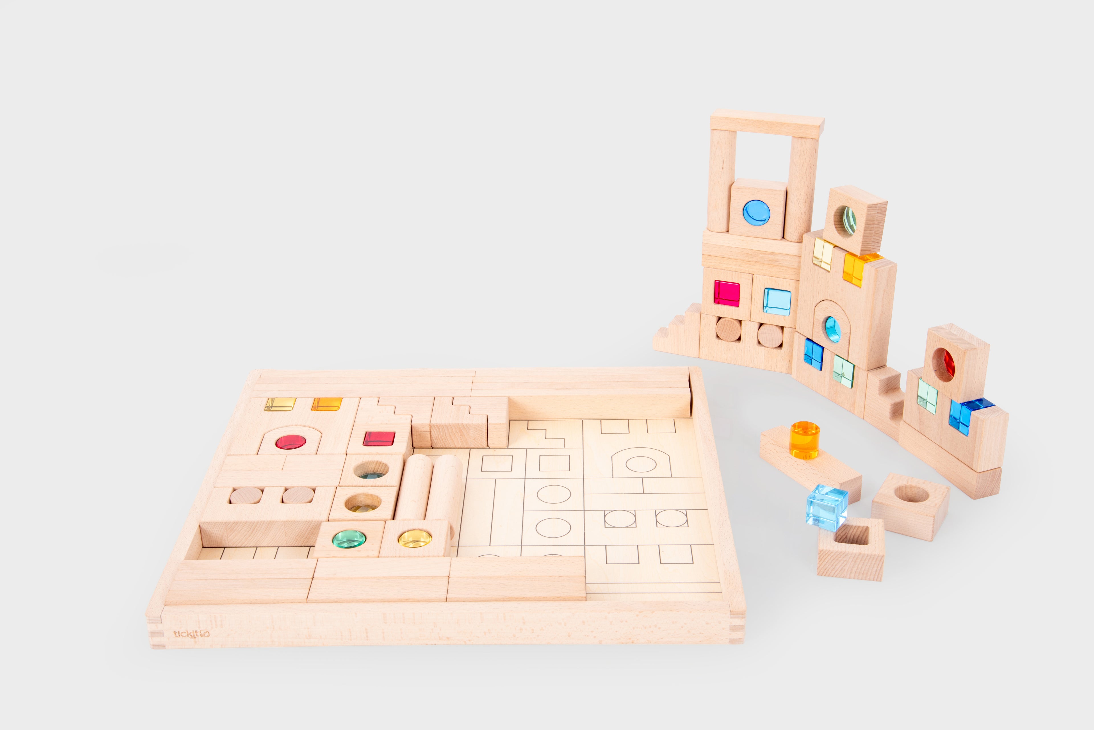 Wooden gem building blocks set with colorful inset circles and square tiles.