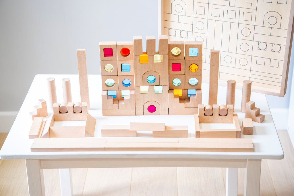 Wooden gem building blocks playset with tall posts and multicolor inset tiles.