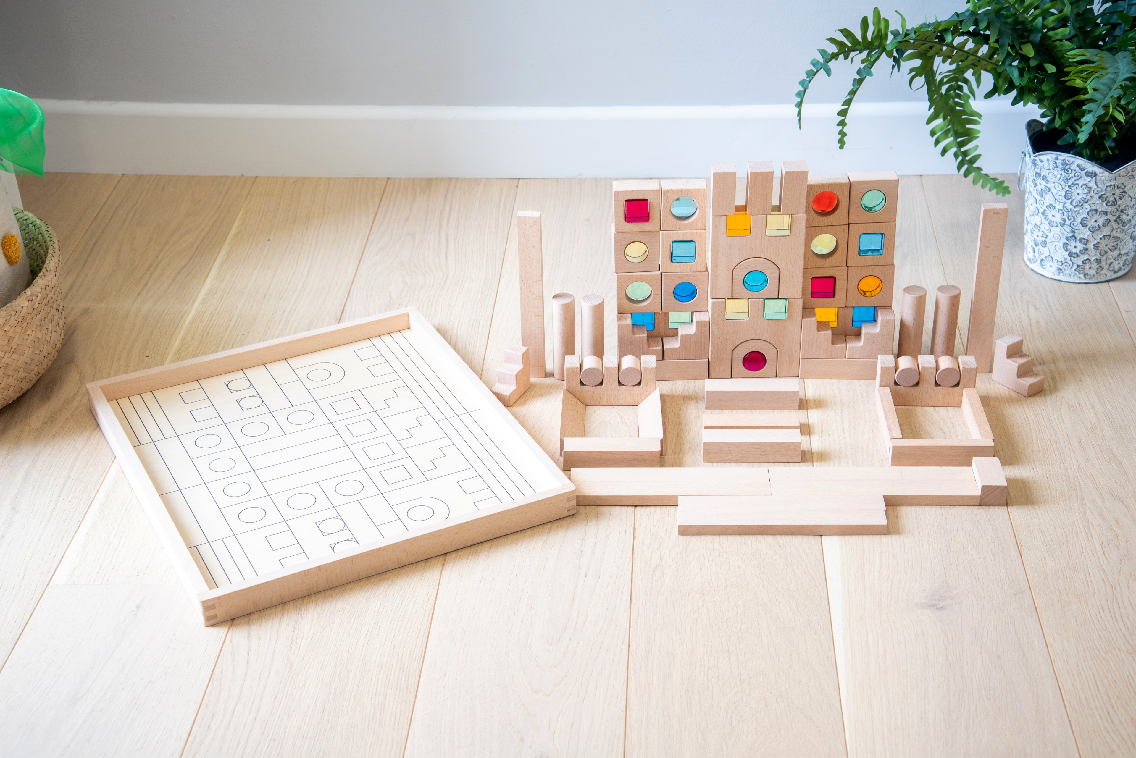 Wooden gem building blocks set on light base board with colorful inset circles.