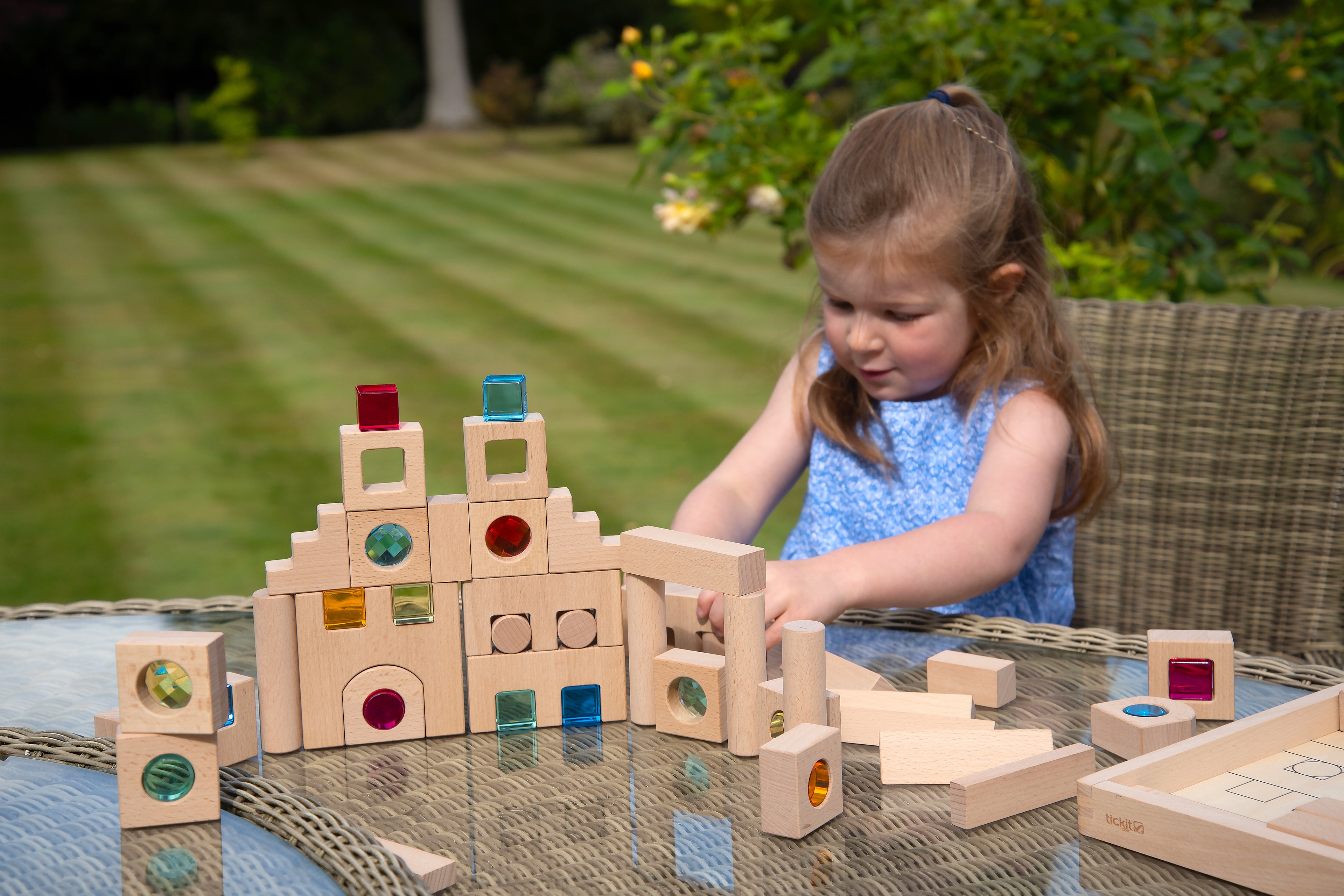 Wooden gem building blocks set with colorful inset pieces, arranged for play.