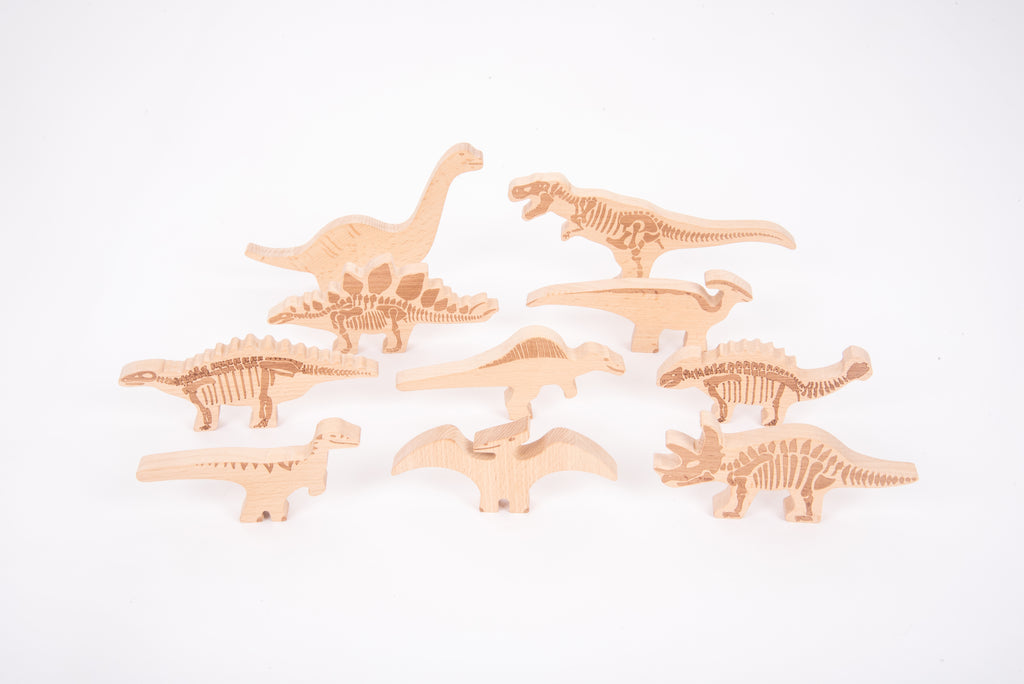 Wooden dinosaur blocks set with carved skeleton details in light wood, multiple pieces