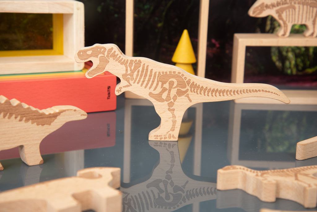 Long-tailed wooden dinosaur block with engraved ribs, carved from light wood