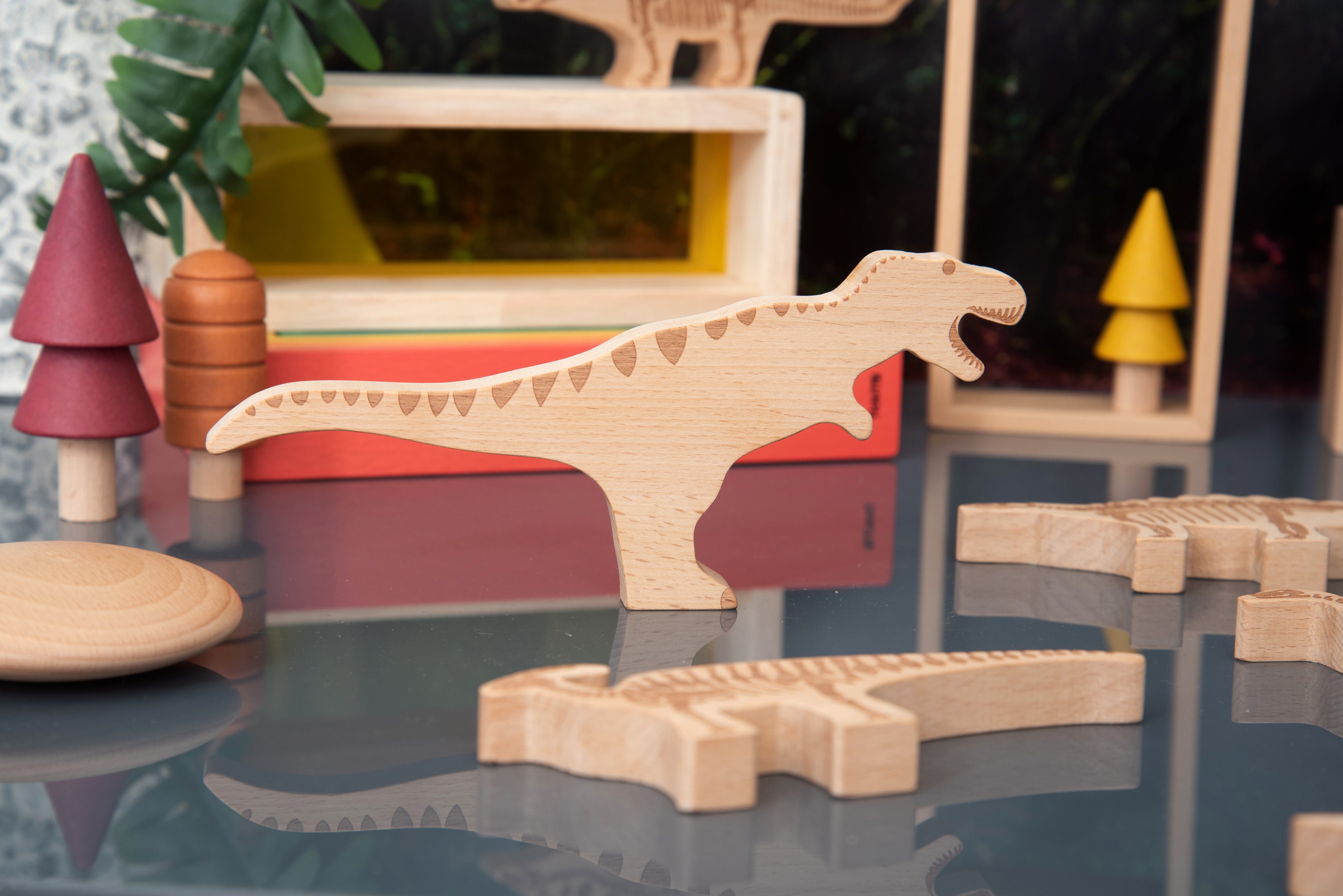 Wooden dinosaur block with long tail, light wood and engraved skeleton pattern