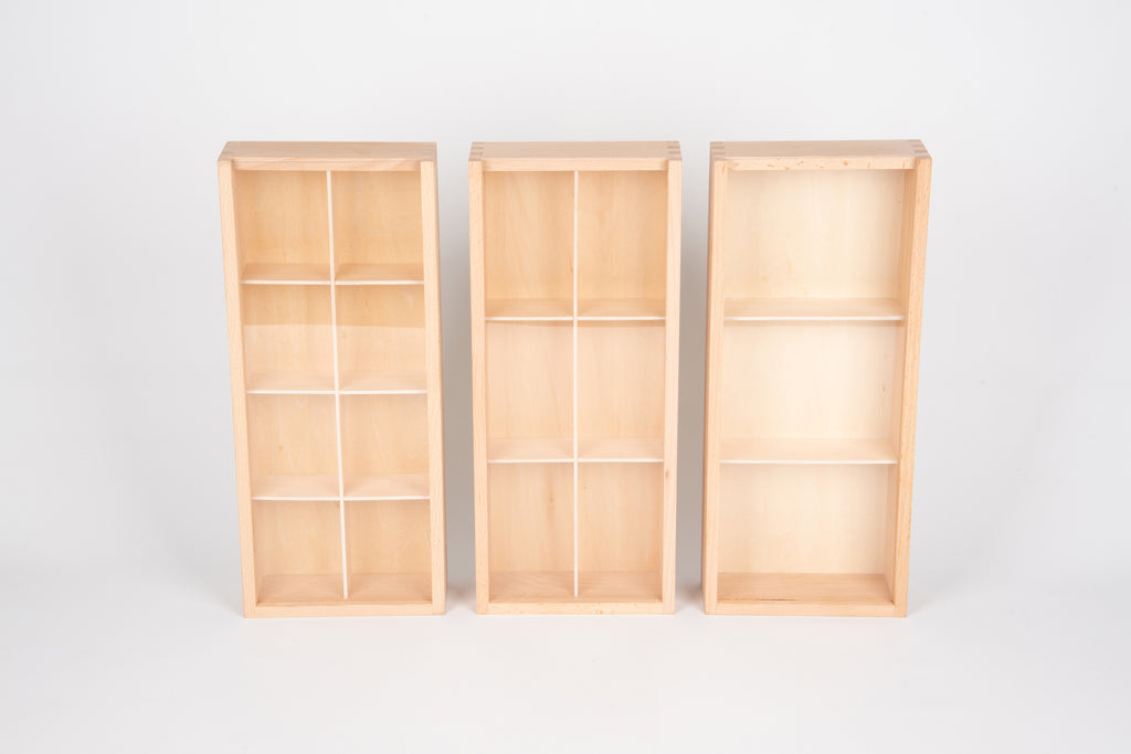 Three upright wooden storage boxes with grid compartments, empty