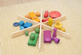 Light wood star divider with colorful foam blocks on striped fabric surface