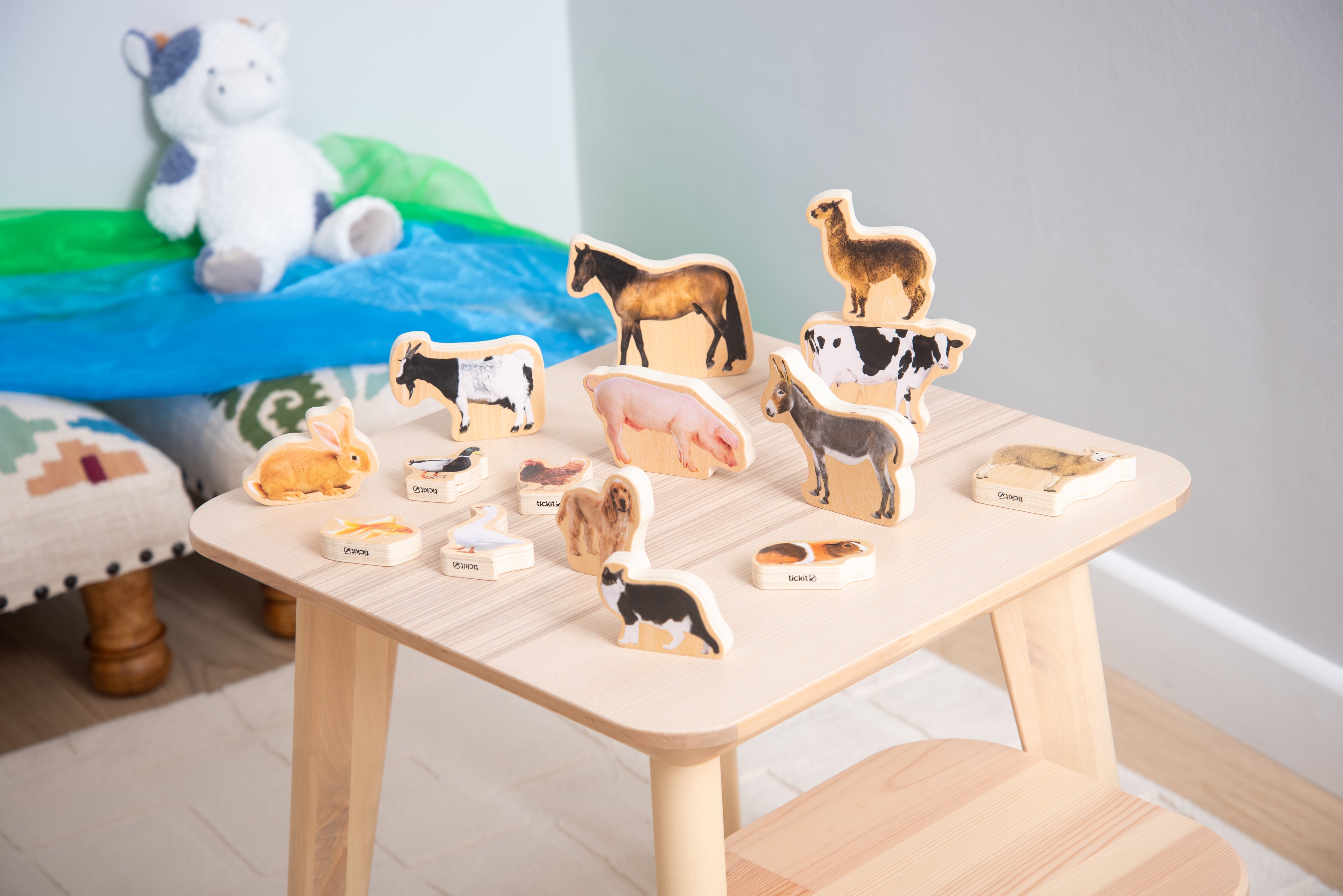 Wooden domestic animal blocks displayed on a small wooden table