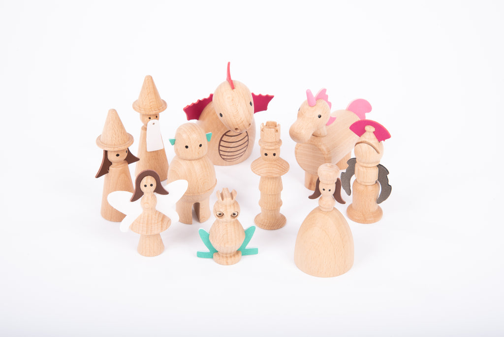 Wooden enchanted figure set with multiple characters in light wood and pink details