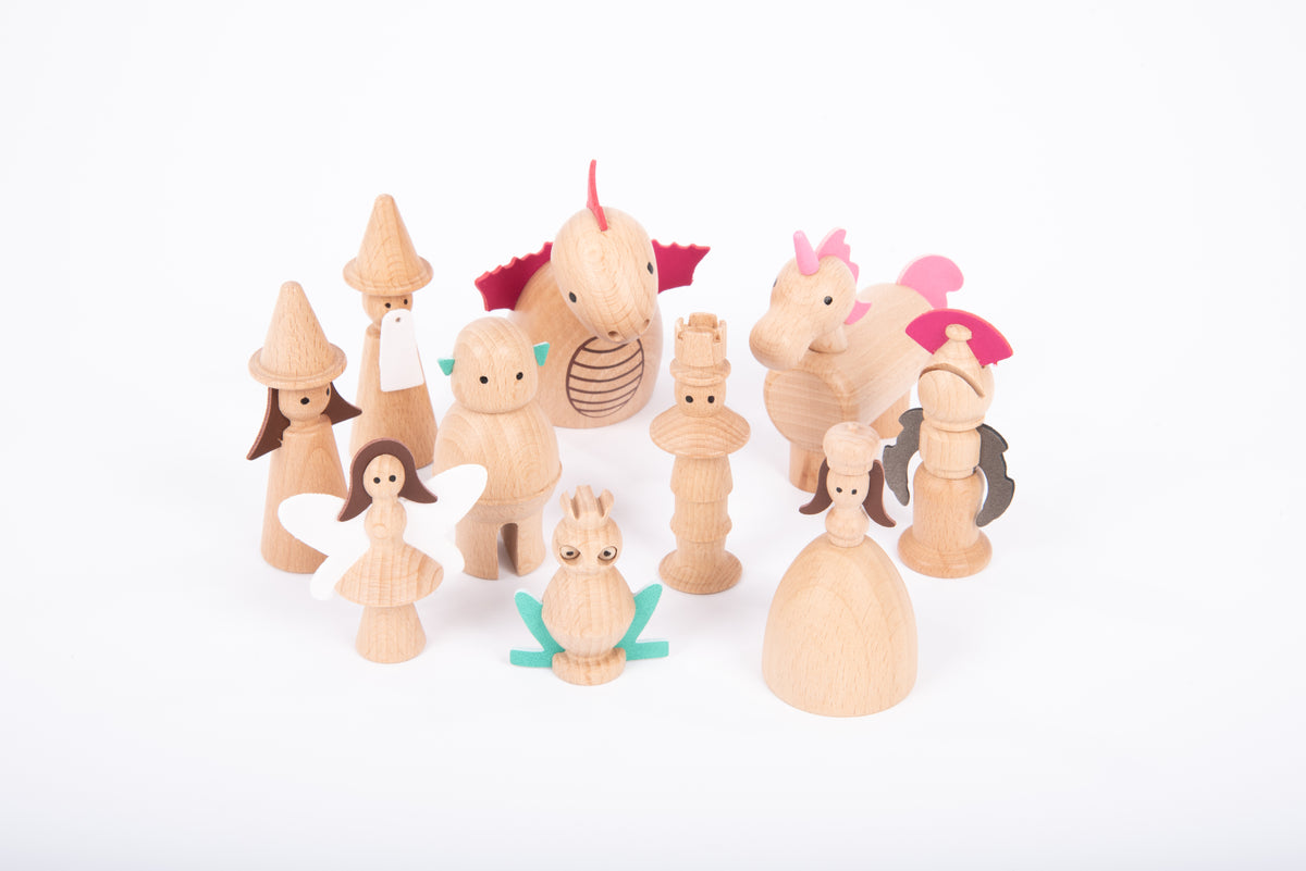 Wooden enchanted figure set with multiple characters in light wood and pink details