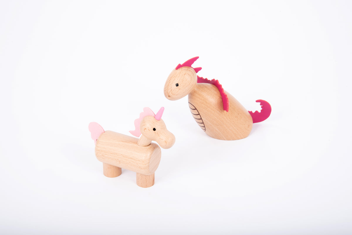 Wooden unicorn and small animal figure with pink horn, mane, and light wood bodies