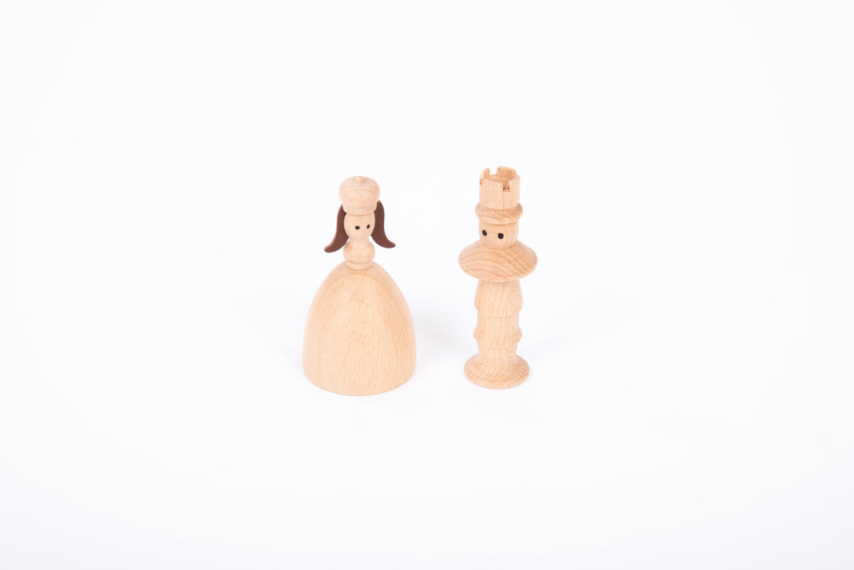 Two wooden figures: a woman doll in a dress and a nutcracker-style character