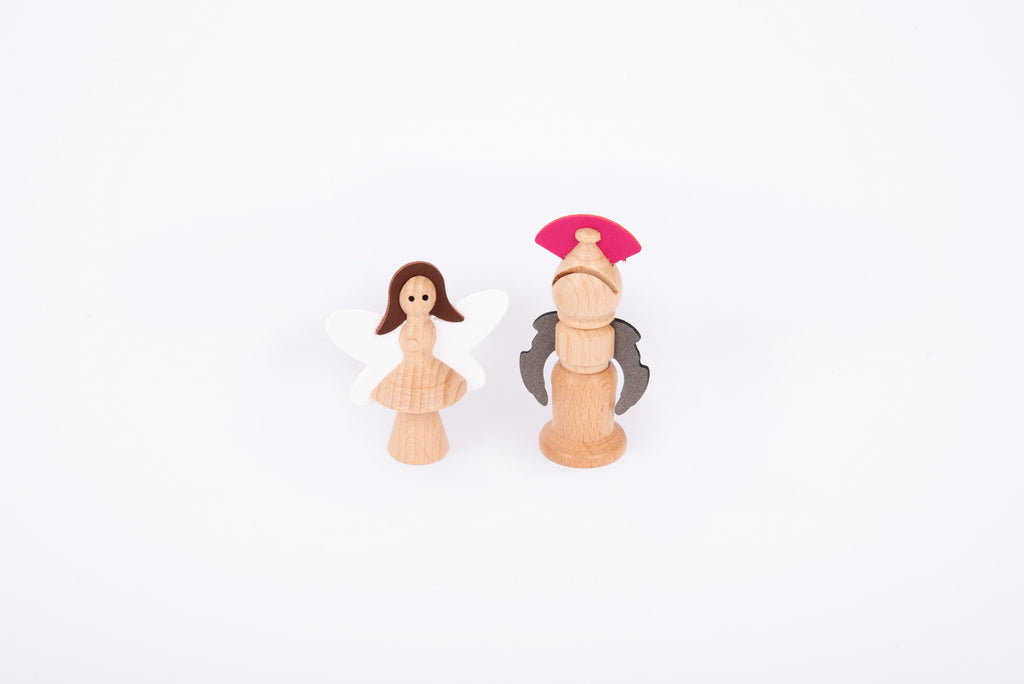 Two wooden characters: a winged fairy figure and a nutcracker soldier