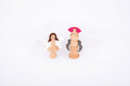 Two wooden characters: a winged fairy figure and a nutcracker soldier